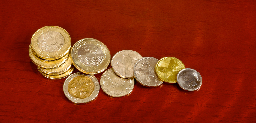 Money - new coins on rosewood table